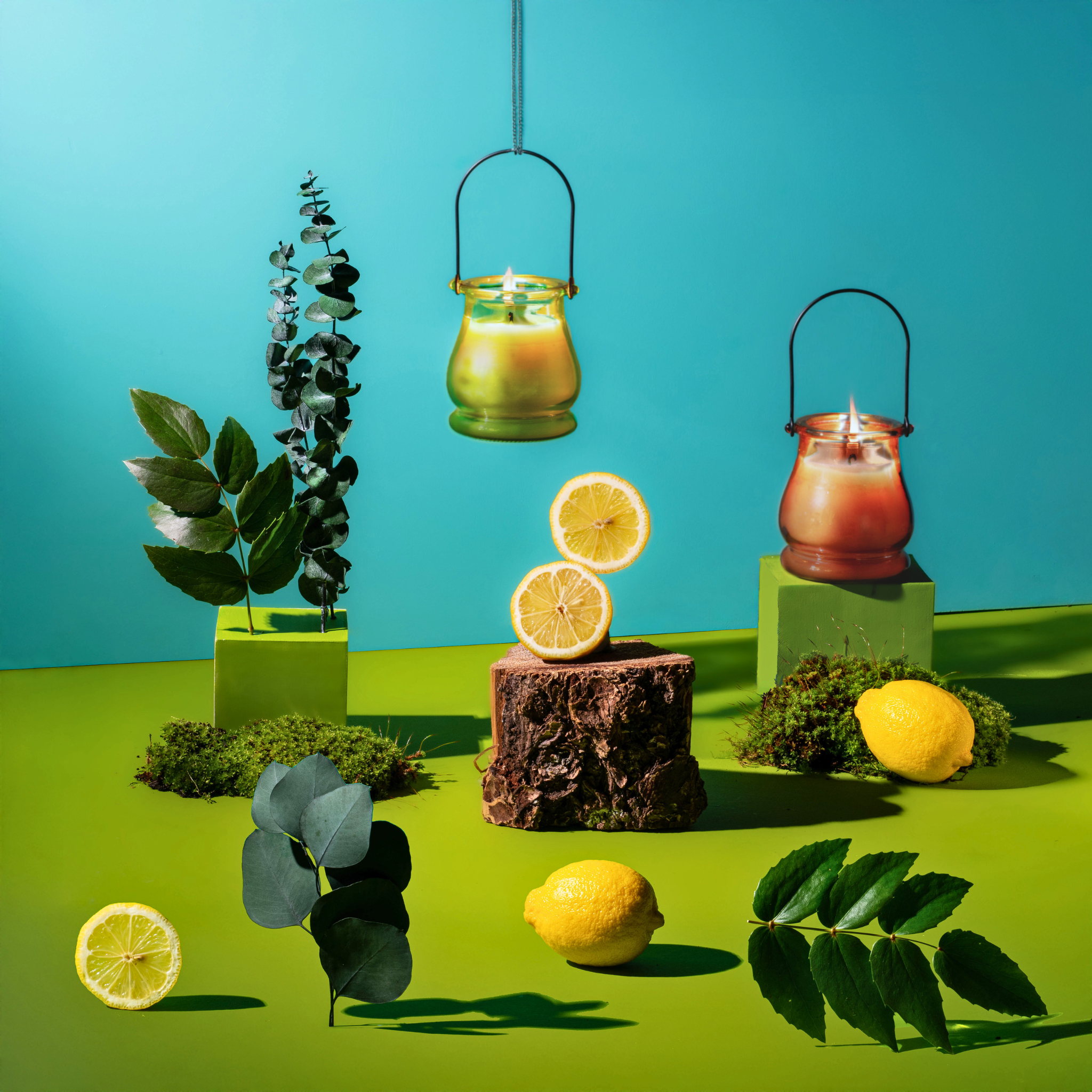 Lemons, leaves, and lanterns on a green platform with a blue background