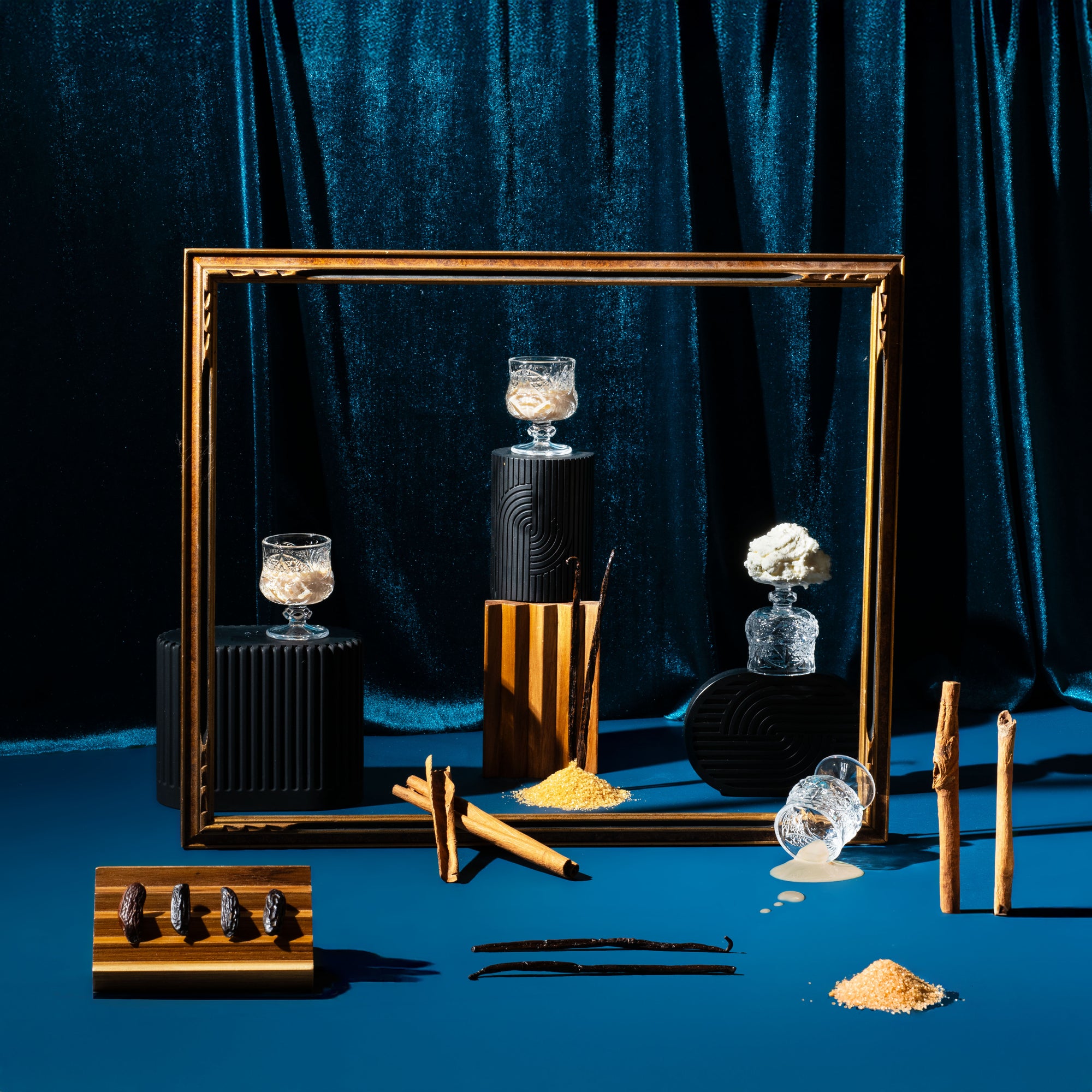 Decorative setup with candles, a mirror, and other items on a blue background