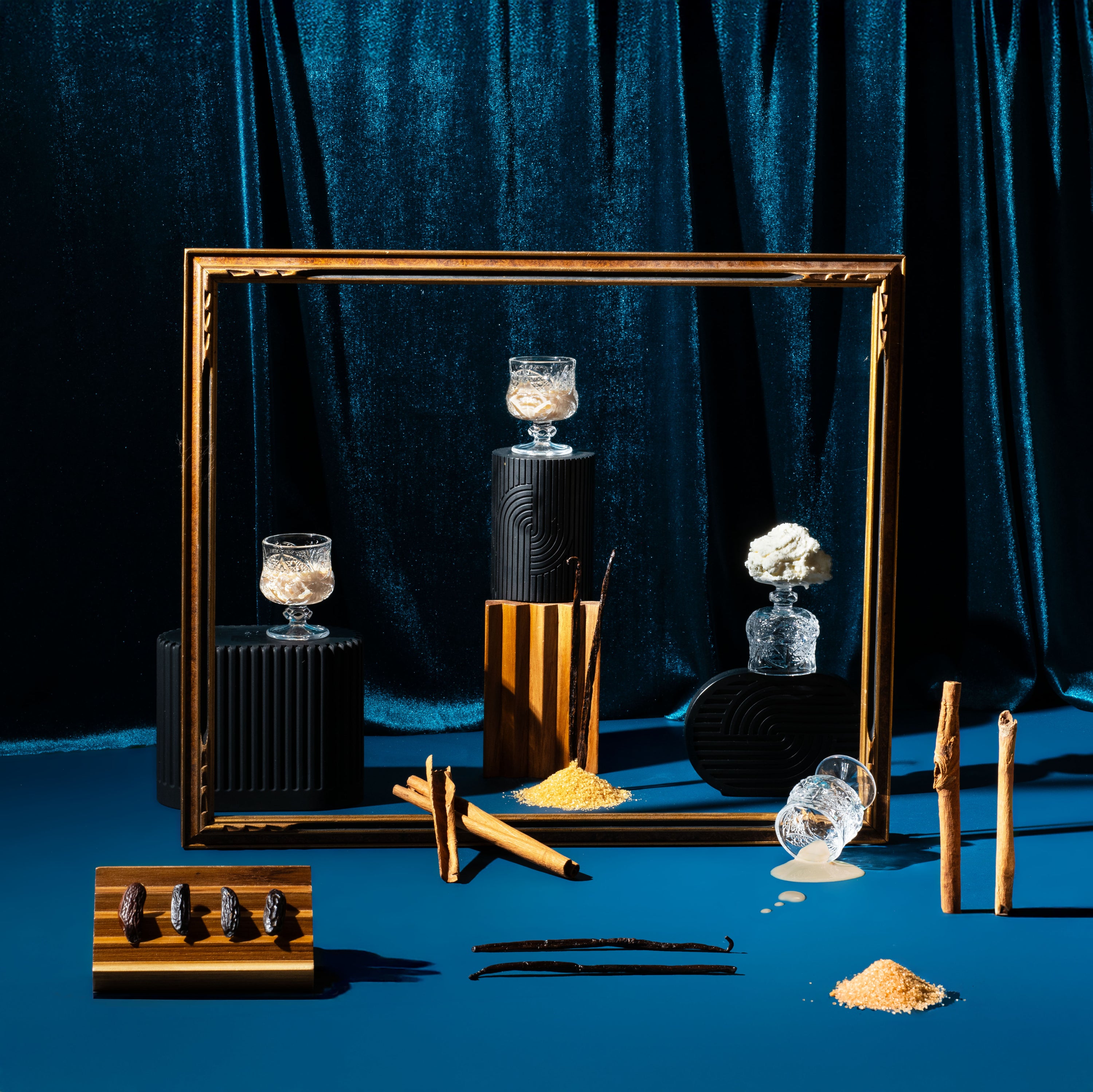 Decorative setup with candles, a mirror, and other items on a blue background