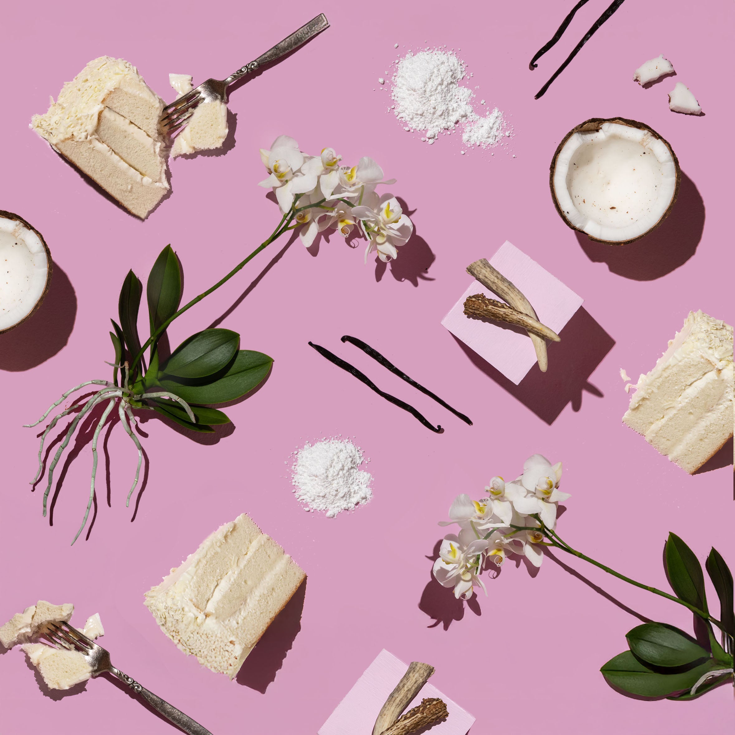 Sweet treats and vanilla beans on a pink background