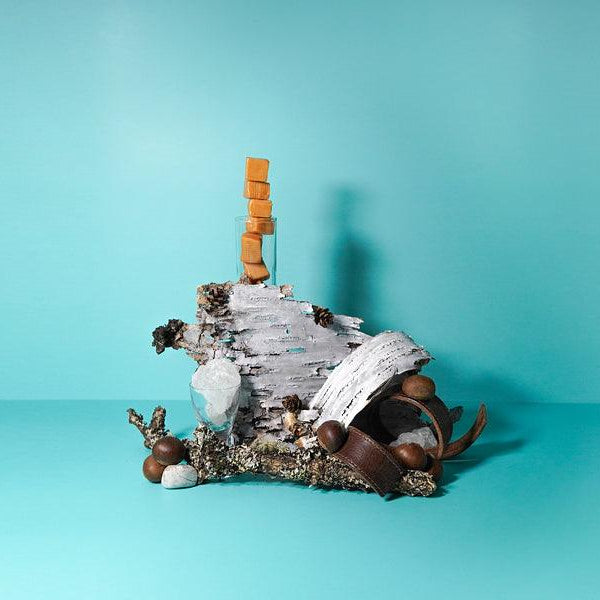 Caramel stacked high with birchwood and chestnuts around on a sky but background